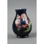 A SMALL MOORCROFT POTTERY VASE, 'Anemone' pattern on blue ground, impressed marks to base, height