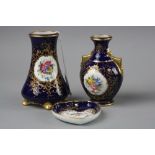 TWO COALPORT MINIATURE VASES AND A PIN DISH, all with florally hand painted inserts, on blue and