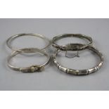 FOUR MIXED SILVER BANGLES, total approximate weight 64.2 grams