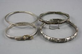 FOUR MIXED SILVER BANGLES, total approximate weight 64.2 grams