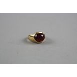 A 9CT SIGNET RING SET WITH A CABACHON GARNET, ring size L, approximate weight 4.3 grams