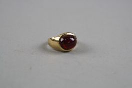 A 9CT SIGNET RING SET WITH A CABACHON GARNET, ring size L, approximate weight 4.3 grams