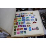 AN ALL WORLD COLLECTION OF STAMPS, in two large home made albums