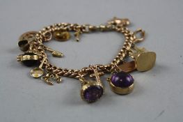 A 9CT CHARM BRACELET WITH VARIOUS CHARMS, total weight approximately 29.0 grams