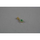 A GOLD EMERALD AND DIAMOND PENDANT, total approximate weight 1.8 grams