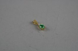 A GOLD EMERALD AND DIAMOND PENDANT, total approximate weight 1.8 grams