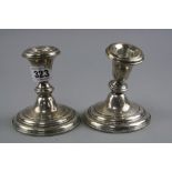 A PAIR OF SILVER DWARF CANDLESTICKS (sd)