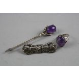 THREE PIECES OF SILVER JEWELLERY, to include an Amethyst carved ring, an Amethyst brooch and another