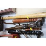 A COLLECTION OF WOODEN TRUNCHEONS, to include a turned and shaped example (5)