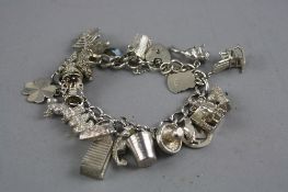 A SILVER CHARM BRACELET WITH VARIOUS CHARMS, total weight approximately 75.5 grams