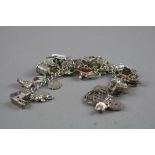 A SILVER CHARM BRACELET WITH VARIOUS CHARMS, approximate weight 77 grams