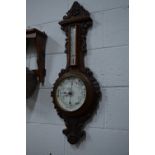 A VICTORIAN CARVED OAK ANEROID BAROMETER