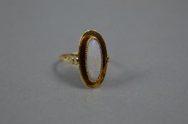 AN EARLY MID 20TH CENTURY OPAL SINGLE STONE RING, opal measuring approximately 15mm x 6mm, bead