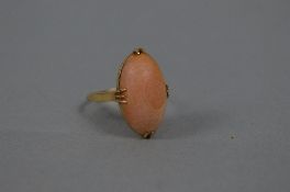 A SINGLE STONE OVAL CABOCHON CUT CORAL RING, coral measuring approximately 21mm x 12mm, ring size