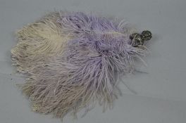 A GEORGE V SILVER HANDLED LILAC OSTRICH FEATHER FAN, the handle embossed as a young woman with