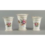 A garniture of English porcelain trumpet shaped spill vases, early 19th century, moulded with beaded