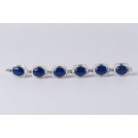 A lapis lazuli, diamond and enamel bracelet, six plaques each with a central cabochon lapis,