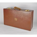 Cartier, a brown leather suitcase, early 20th century, gilt metal hardware and lock plate stamped