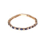 A sapphire and clear stone line bracelet,