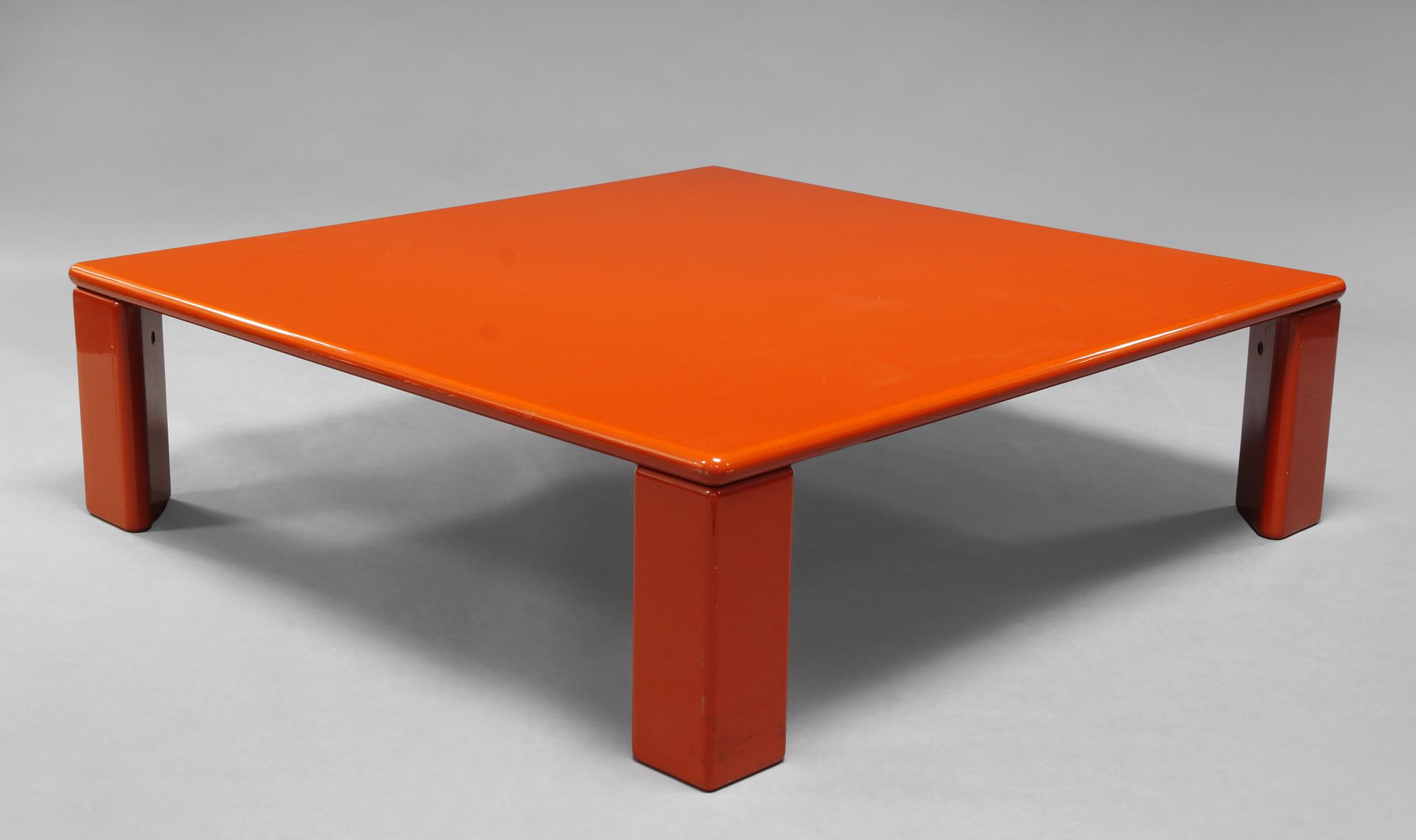 A red lacquered square low table, c.