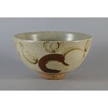 Henry Hammond, British 1914-1986, a stoneware bowl with painted decoration in brown in a green