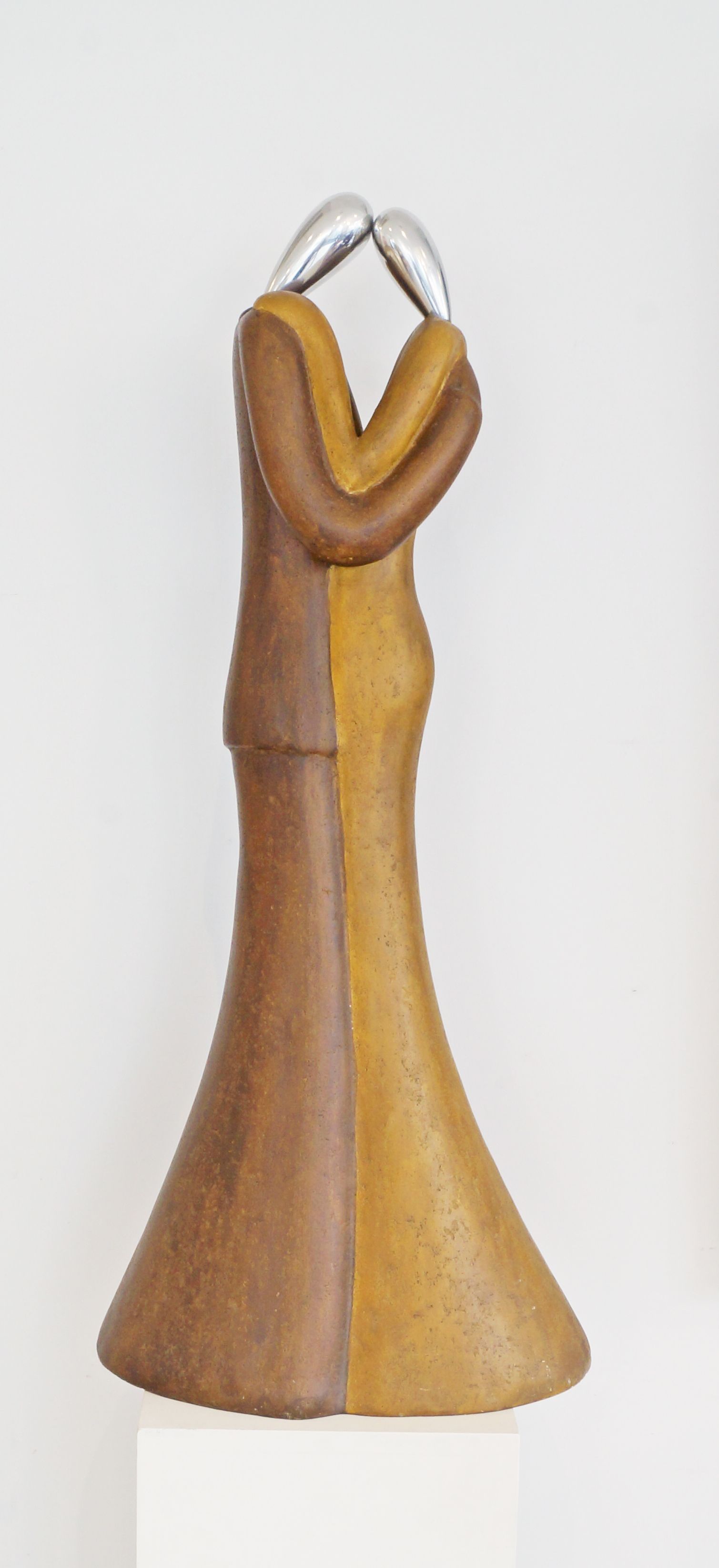 A contemporary sculpture of two lovers embracing, wood, metal and varnish, 100cm high,