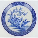 A large Japanese blue and white porcelain charger, Meiji Period, decorated to the centre with