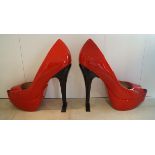 An oversized pair of red shoes; fibre glass, material and metal, approx 156x139cm