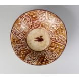 A Samanid brown and yellow pottery bowl, Central Asia or North East Iran, 10th century,