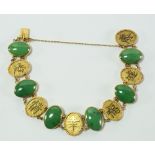 A Chinese 14k yellow gold and jade set bracelet,