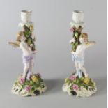 A pair of German porcelain single candlesticks, late 19th/early 20th century,