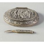 A Dutch white metal oval snuff box, the hinged cover moulded with a tavern scene, approx 6.