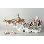 A Lladro porcelain model of Santa Claus, 20th century, 61cm wide, together with two models of frogs,