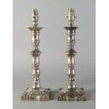 A pair of early 20th century silver plated table lamps, in the style of Georgian candlesticks,