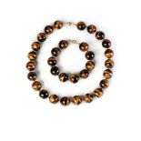 A tigers eye agate bead necklace, twenty two large agate beads, approx 2cm diameter,