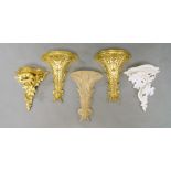 A pair of giltwood wall brackets, with semi-circular plateau, on stiff foliate supports, 43cm high,