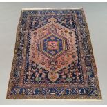 A modern Kashan pattern rug with oval tree of life medallion within floral and foliate field,