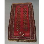 A Tekke rug with honeycomb deep red field within multiple border, 157cm x 87cm,