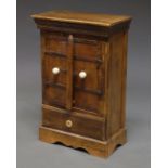 A North African hardwood cabinet, with two doors with bone spherical handles, above single drawer,