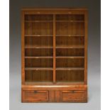 A Victorian oak three section library book case, with plain cushion cresting,