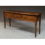 An 18th century style walnut three drawer side table, 20th century, on square tapering supports,