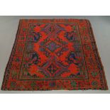 A Turkish carpet in Ushak style with three medalions, deep red field,