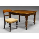 An oak extending dining table, early 20th century, on turned legs, with ceramic castors,