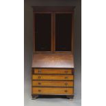 An Edwardian mahogany inlaid bureau bookcase, drop front over four long drawers,