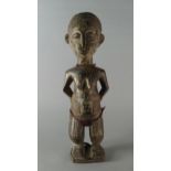 A tribal carved figure of a woman, Baule,