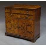 A walnut sideboard, early 20th century, with two long drawers above cupboards, on plinth base,