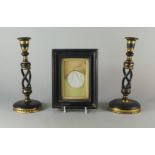 A pair of Victorian lacquered and gilt candlesticks, with writhen openwork shafts, on domed bases,