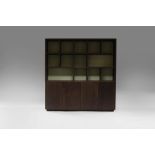 A Louise Bradley black ash bookcase, the upper tier with segmented shelves,