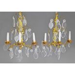 A pair of cut glass and gilt metal three branch wall lights, late 19th/early 20th century,