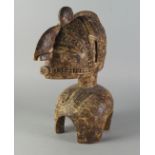 A large Tribal hardwood figural head dress, late 19th/20th century, in the form of head of a man,